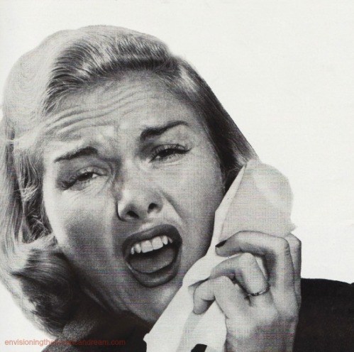 vintage image woman sneezing into tissue